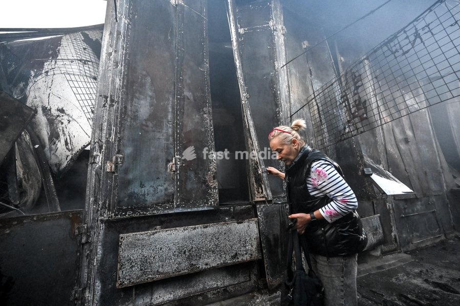 An entrepreneur approaches a burnt-out and deformed retail stall at the Central Clothes Market (Anholenko) in Zaporizhzhia, Ukraine, September 26, 2026. The market sustained significant damage in a Russian drone attack