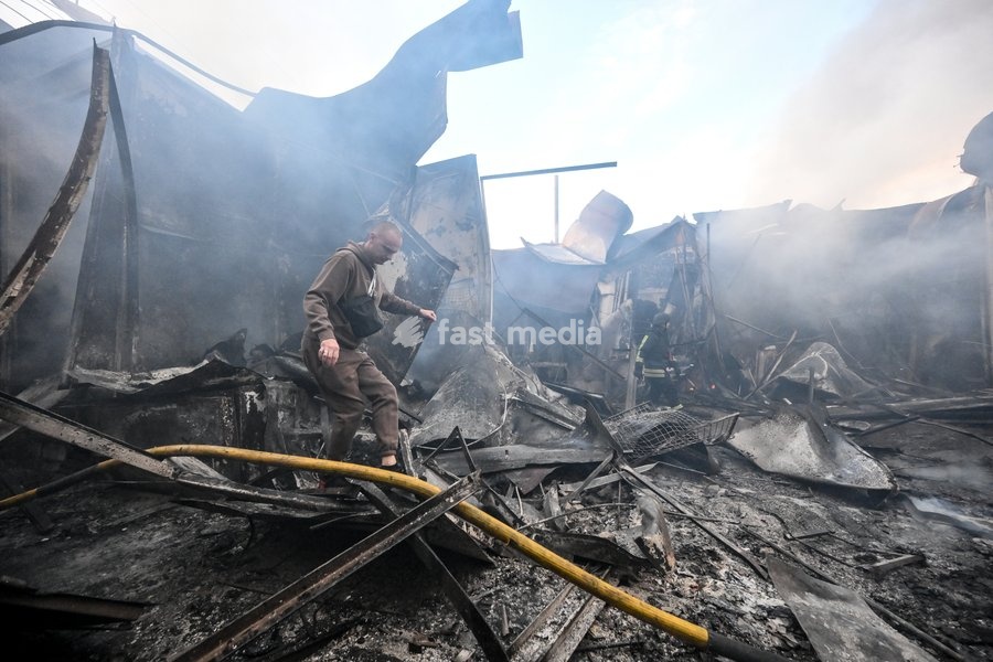 An entrepreneur walks through piles of burnt scrap metal among the destroyed rows of stalls at the Central Clothes Market (Anholenko) in Zaporizhzhia, Ukraine, September 26, 2026. The market sustained significant damage in a Russian drone attack