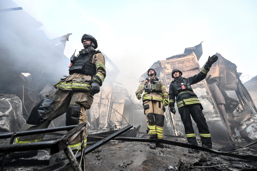 State Emergency Service rescuers work amid burnt-out metal containers at the Central Clothes Market (Anholenko) in Zaporizhzhia, Ukraine, September 26, 2026. The market sustained significant damage in a Russian drone attack