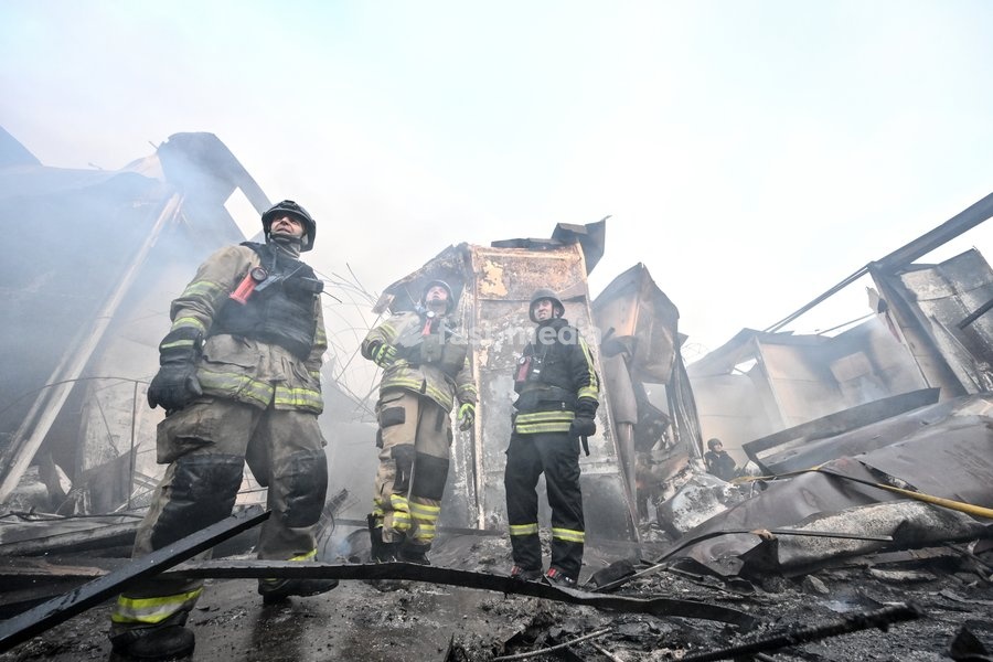 State Emergency Service rescuers work amid burnt-out metal containers at the Central Clothes Market (Anholenko) in Zaporizhzhia, Ukraine, September 26, 2026. The market sustained significant damage in a Russian drone attack