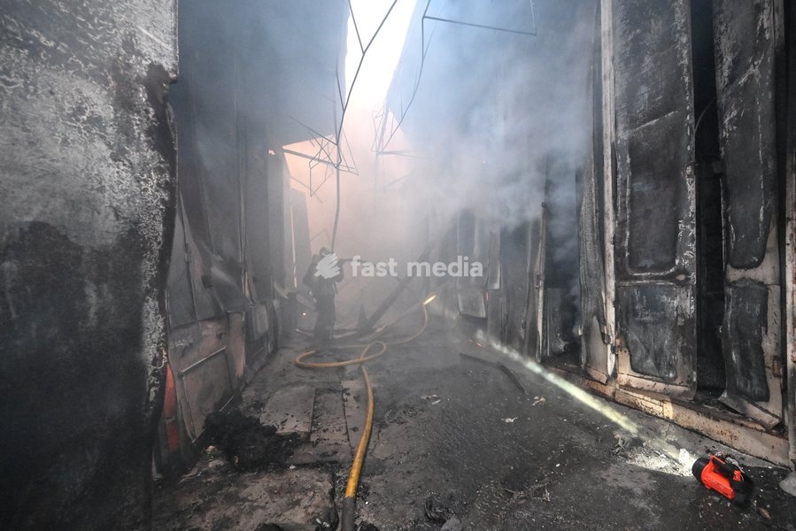A State Emergency Service rescuer, wearing protective gear, works in a smoke-filled passageway to extinguish a fire at the Central Clothes Market (Anholenko) in Zaporizhzhia, Ukraine, September 26, 2026. The market sustained significant damage in a Russian drone attack