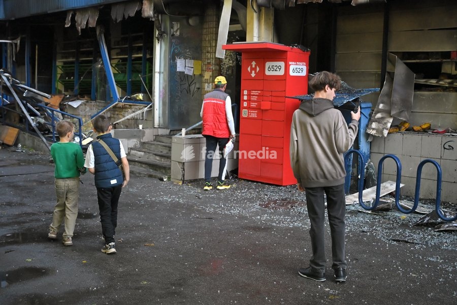 Boys stand outside a damaged supermarket on the ground floor of a five-storey apartment block in the Solomianskyi district after a Russian drone attack, Kyiv, Ukraine, September 26, 2026. During the morning assault on the capital, a Russian drone exploded close to the residential building. A fire…