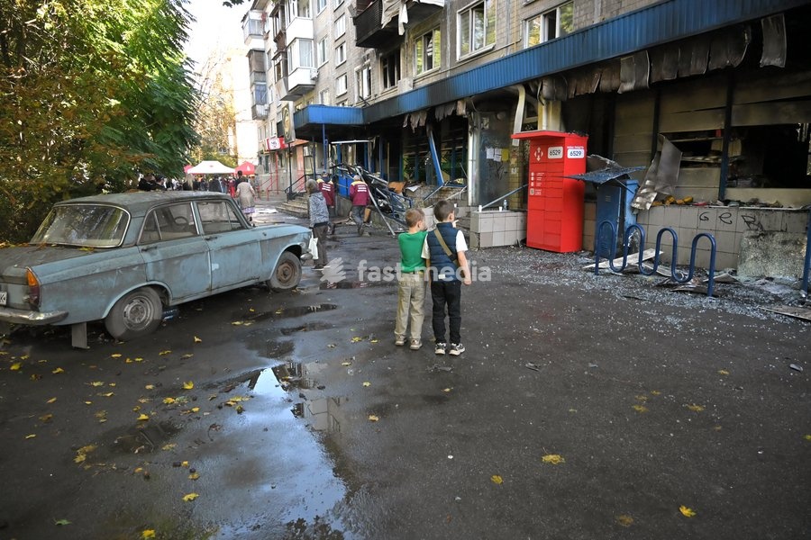 Boys stand outside a damaged supermarket on the ground floor of a five-storey apartment block in the Solomianskyi district after a Russian drone attack, Kyiv, Ukraine, September 26, 2026. During the morning assault on the capital, a Russian drone exploded close to the residential building. A fire…