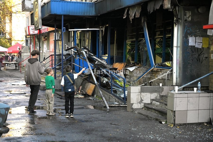 Boys stand outside a damaged supermarket on the ground floor of a five-storey apartment block in the Solomianskyi district after a Russian drone attack, Kyiv, Ukraine, September 26, 2026. During the morning assault on the capital, a Russian drone exploded close to the residential building. A fire…