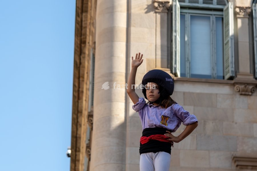 A young girl at the top of a human tower celebrates as members of Castellers de Terrassa perform during the traditional La Mercè festival celebrations, September 27, 2026, Plaça Sant Jaume, Barcelona, Catalonia