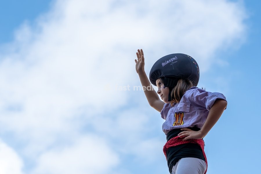 A young girl at the top of a human tower celebrates as members of Castellers de Terrassa perform during the traditional La Mercè festival celebrations, September 27, 2026, Plaça Sant Jaume, Barcelona, Catalonia