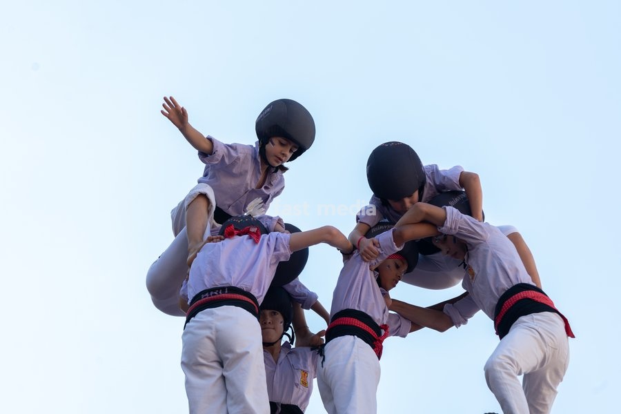 An enxaneta reaches the top of a human tower built by Castellers de Terrassa during the traditional La Mercè festival celebrations, September 27, 2026, Plaça Sant Jaume, Barcelona, Catalonia
