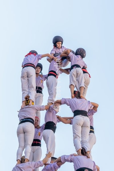 An enxaneta reaches the top of a human tower built by Castellers de Terrassa during the traditional La Mercè festival celebrations, September 27, 2026, Plaça Sant Jaume, Barcelona, Catalonia