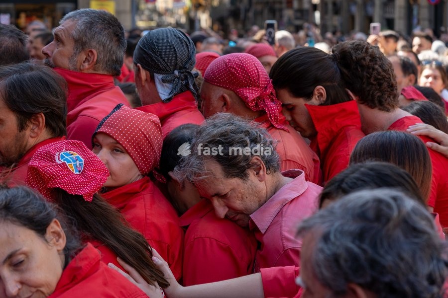 A member of Castellers de Terrassa helps Colla Jove dels Xiquets de Valls by forming part of the pinya base during the traditional La Mercè festival celebrations, September 27, 2026, Plaça Sant Jaume, Barcelona, Catalonia