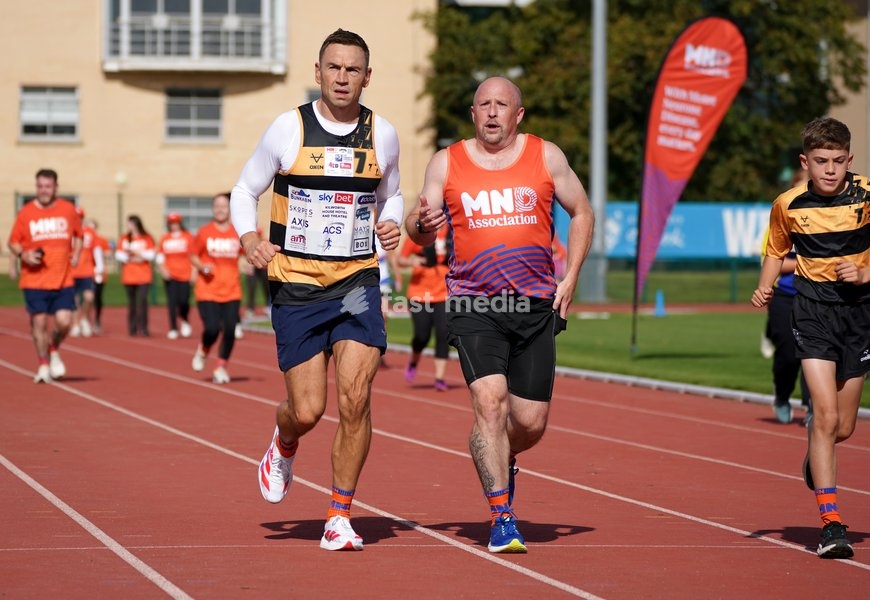 YORK, ENGLAND - SEPTEMBER 28: Sir Kevin Sinfield (L) runs around the track with an MND supporter during the 7 in 7: The Grand Finale at the University of York Athletics Track on September 28, 2026 in York, England. Sir Kevin Sinfield is running an ultra marathon every day for seven days to raise…