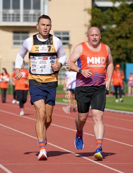 YORK, ENGLAND - SEPTEMBER 28: Sir Kevin Sinfield () runs around the track with an MND supporter during the 7 in 7: The Grand Finale at the University of York Athletics Track on September 28, 2026 in York, England. Sir Kevin Sinfield is running an ultra marathon every day for seven days to raise…