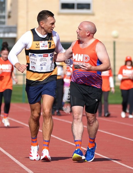 YORK, ENGLAND - SEPTEMBER 28: Sir Kevin Sinfield (L) runs around the track with an MND supporter during the 7 in 7: The Grand Finale at the University of York Athletics Track on September 28, 2026 in York, England. Sir Kevin Sinfield is running an ultra marathon every day for seven days to raise…