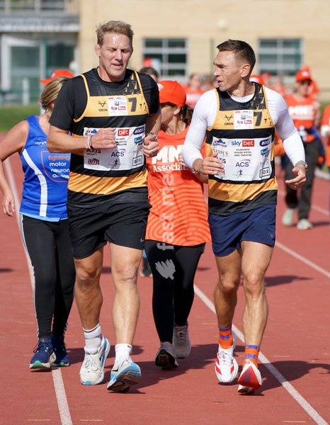 YORK, ENGLAND - SEPTEMBER 28: Lewis Moody and Sir Kevin Sinfield run around the track with MND supporters during the 7 in 7: The Grand Finale at the University of York Athletics Track on September 28, 2026 in York, England. Sir Kevin Sinfield is running an ultra marathon every day for seven days to…