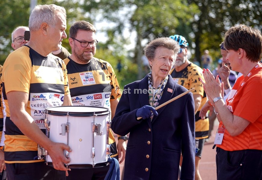 YORK, ENGLAND - SEPTEMBER 28: Princess Anne, Princess Royal speaks with Tanya Curry (R), Chief Executive of the Motor Neurone Disease (MND) Association as she bangs a drum to start the next stage of the race during the 7 in 7: The Grand Finale at the University of York Athletics Track on September…