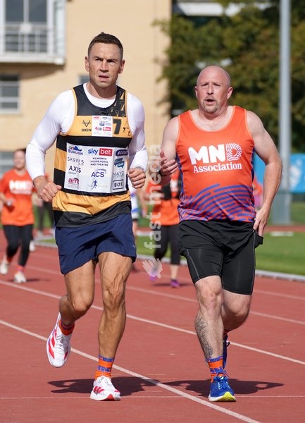 YORK, ENGLAND - SEPTEMBER 28: Sir Kevin Sinfield (L) runs around the track with an MND supporter during the 7 in 7: The Grand Finale at the University of York Athletics Track on September 28, 2026 in York, England. Sir Kevin Sinfield is running an ultra marathon every day for seven days to raise…