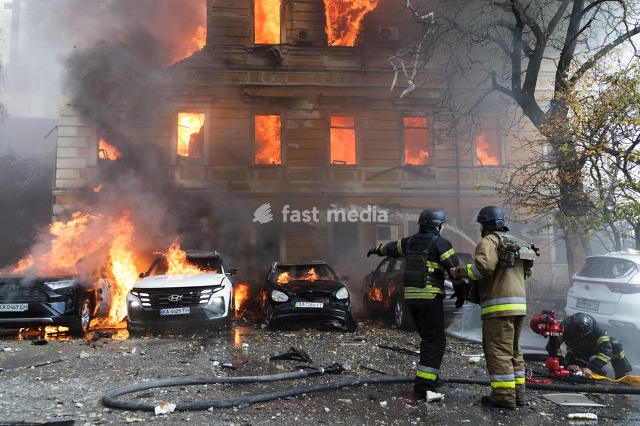Rescuers pour water on burning cars and the National Academy of Sciences building, which is engulfed in flames after being hit by a Russian drone, Kyiv, Ukraine, September 28, 2026. One person was killed, and three others were injured in the attack