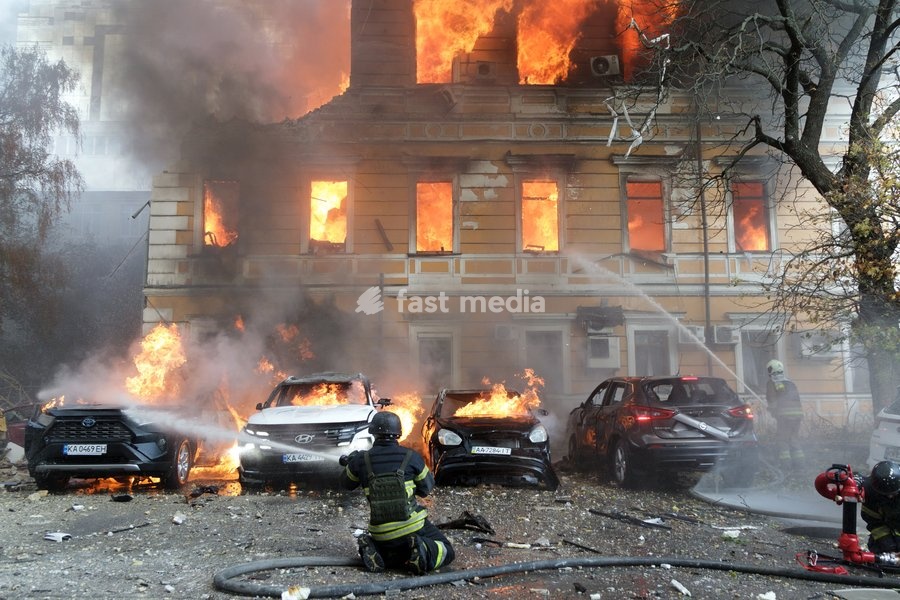Rescuers pour water on burning cars and the National Academy of Sciences building, which is engulfed in flames after being hit by a Russian drone, Kyiv, Ukraine, September 28, 2026. One person was killed and three others injured in the attack