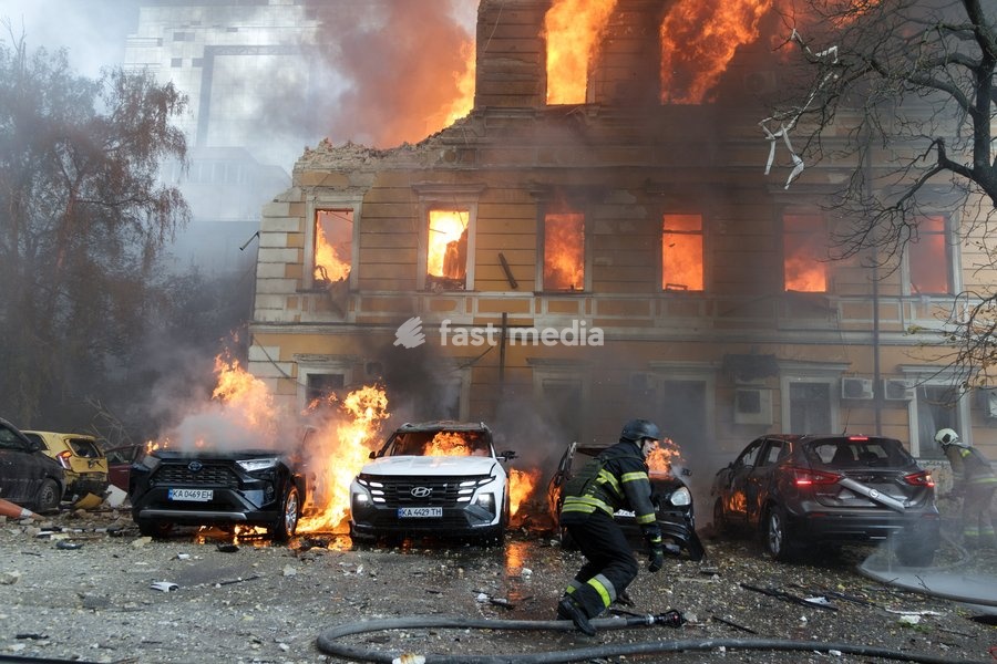 Rescuers pour water on burning cars and the National Academy of Sciences building, which is engulfed in flames after being hit by a Russian drone, Kyiv, Ukraine, September 28, 2026. One person was killed, and three others were injured in the attack