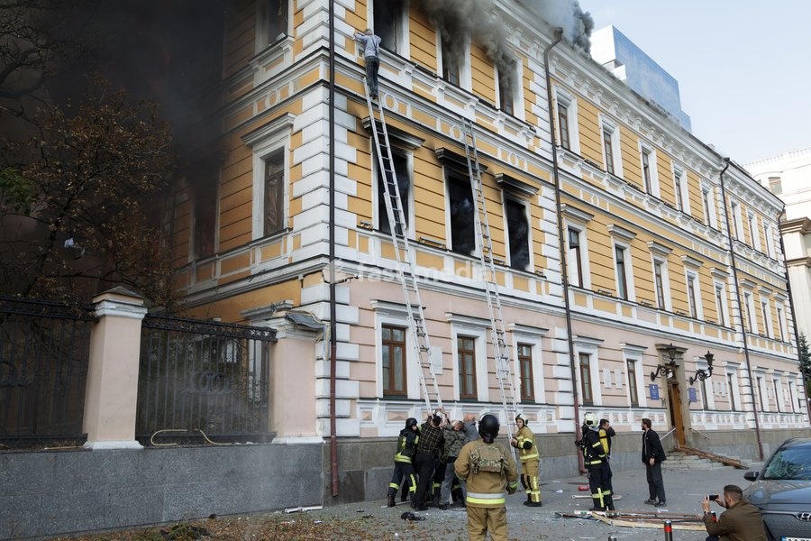 A man goes down a telescopic ladder to escape from the National Academy of Sciences building, which is engulfed in flames after being hit by a Russian drone, in Kyiv, Ukraine, September 28, 2026. One person was killed, and three others were injured in the attack