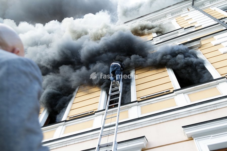 A man goes down a telescopic ladder to escape from the National Academy of Sciences building, which is engulfed in flames after being hit by a Russian drone, in Kyiv, Ukraine, September 28, 2026. One person was killed, and three others were injured in the attack