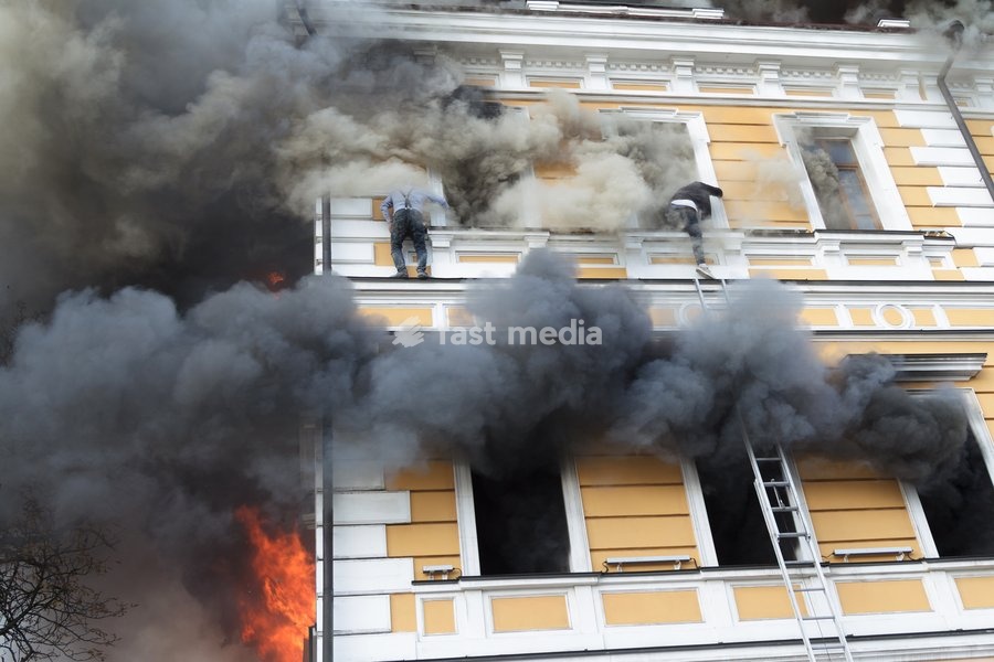 Two men attempt to escape from the National Academy of Sciences building, which is engulfed in flames after being hit by a Russian drone, Kyiv, Ukraine, September 28, 2026. One person was killed, and three others were injured in the attack