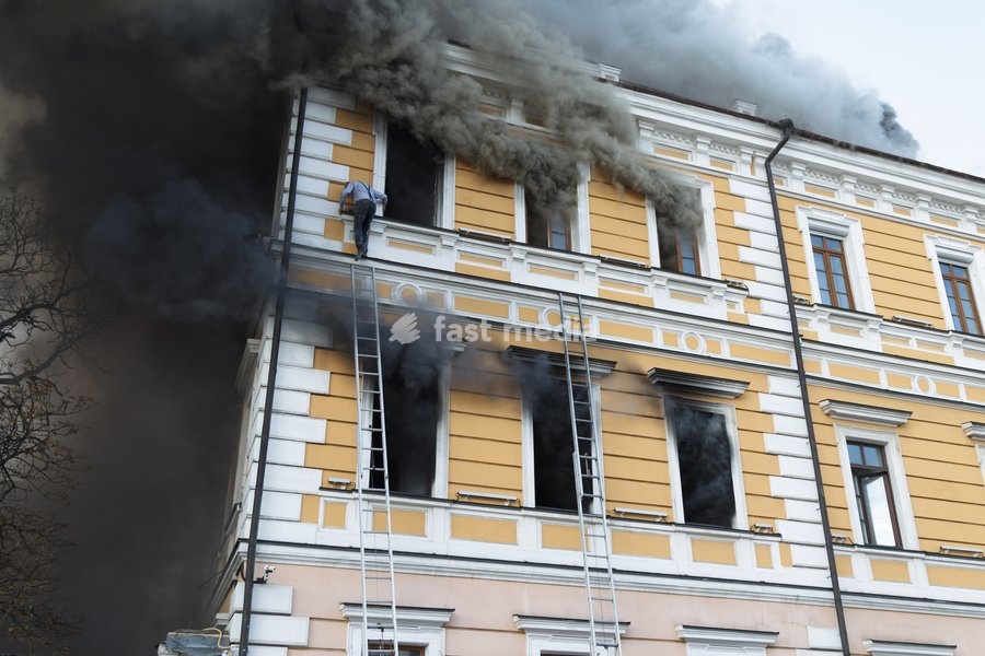 A man goes down a telescopic ladder to escape from the National Academy of Sciences building, which is engulfed in flames after being hit by a Russian drone, in Kyiv, Ukraine, September 28, 2026. One person was killed, and three others were injured in the attack