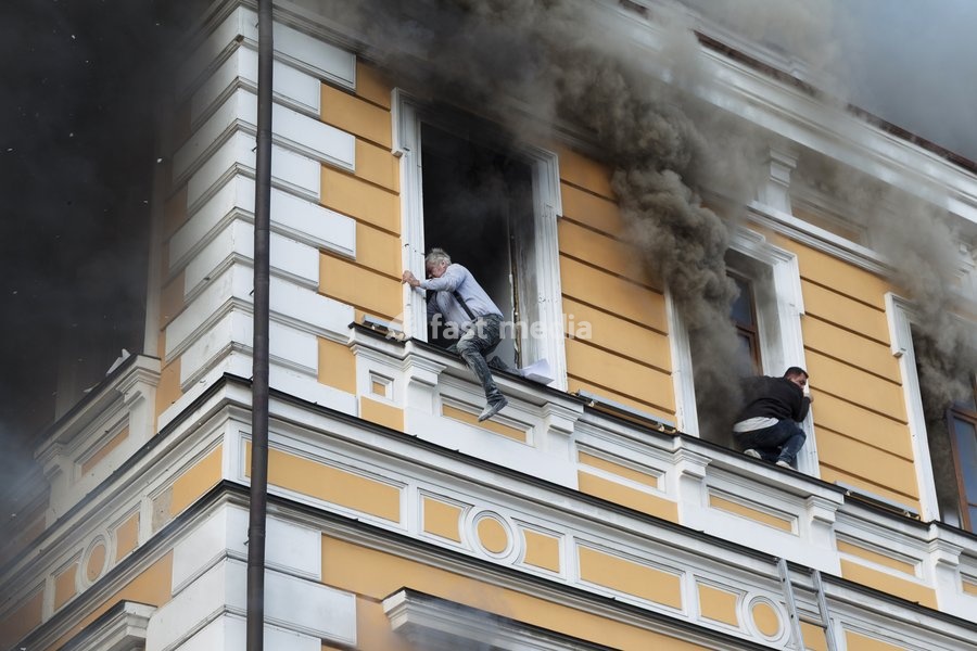 Two men attempt to escape from the National Academy of Sciences building, which is engulfed in flames after being hit by a Russian drone, Kyiv, Ukraine, September 28, 2026. One person was killed, and three others were injured in the attack