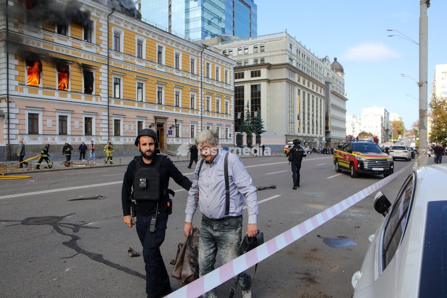 A law enforcer accompanies a man injured in a Russian drone strike on the National Academy of Sciences building, Kyiv, Ukraine, September 28, 2026. One person was killed, and three others were injured in the attack