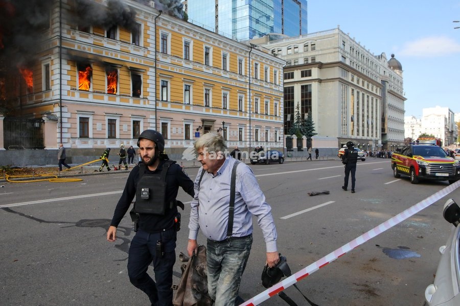 A law enforcer accompanies a man injured in a Russian drone strike on the National Academy of Sciences building, Kyiv, Ukraine, September 28, 2026. One person was killed, and three others were injured in the attack