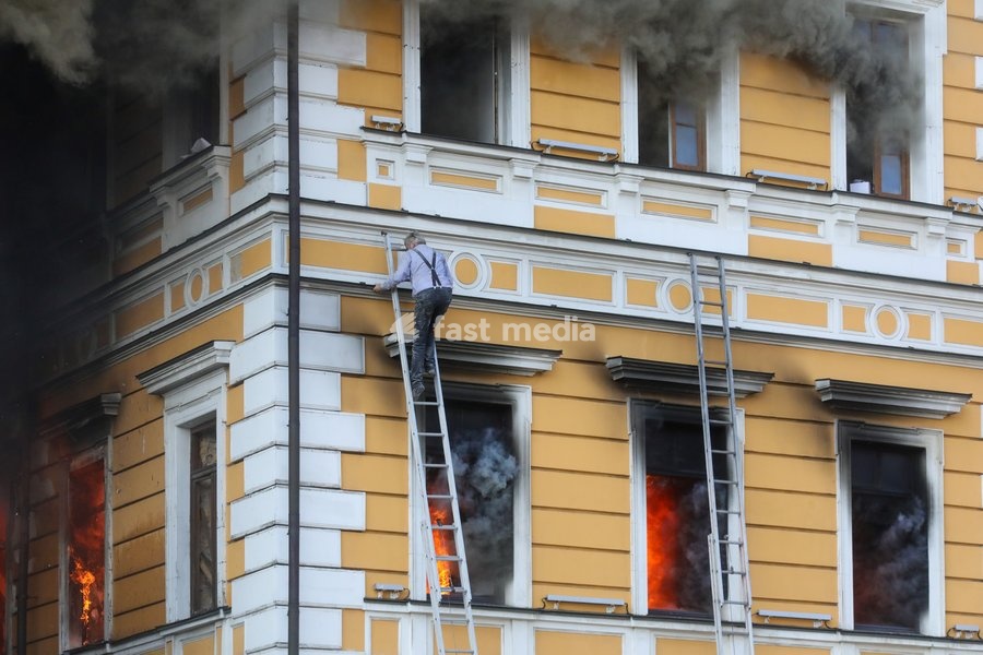 A man goes down a telescopic ladder to escape from the National Academy of Sciences building, which is engulfed in flames after being hit by a Russian drone, Kyiv, Ukraine, September 28, 2026. One person was killed, and three others were injured in the attack