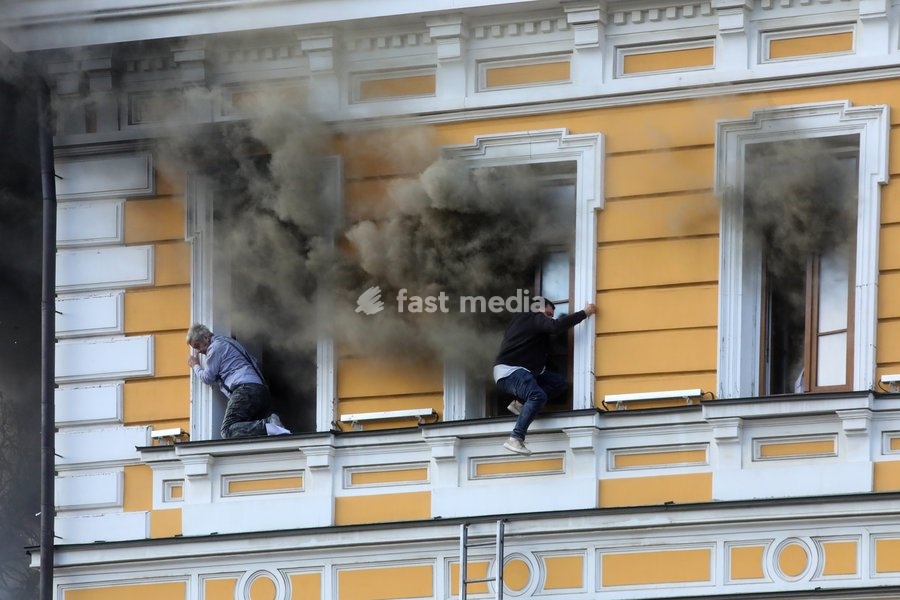 Two men attempt to escape from the National Academy of Sciences building, which is engulfed in flames after being hit by a Russian drone, Kyiv, Ukraine, September 28, 2026. One person was killed, and three others were injured in the attack