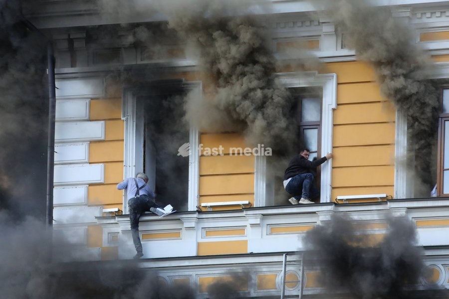 Two men attempt to escape from the National Academy of Sciences building, which is engulfed in flames after being hit by a Russian drone, Kyiv, Ukraine, September 28, 2026. One person was killed, and three others were injured in the attack