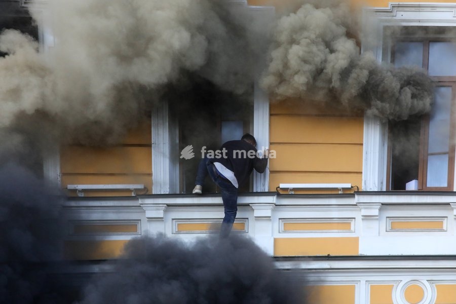 A man tries to escape from the National Academy of Sciences building, which is engulfed in flames after being hit by a Russian drone, in Kyiv, Ukraine, September 28, 2026. One person was killed, and three others were injured in the attack