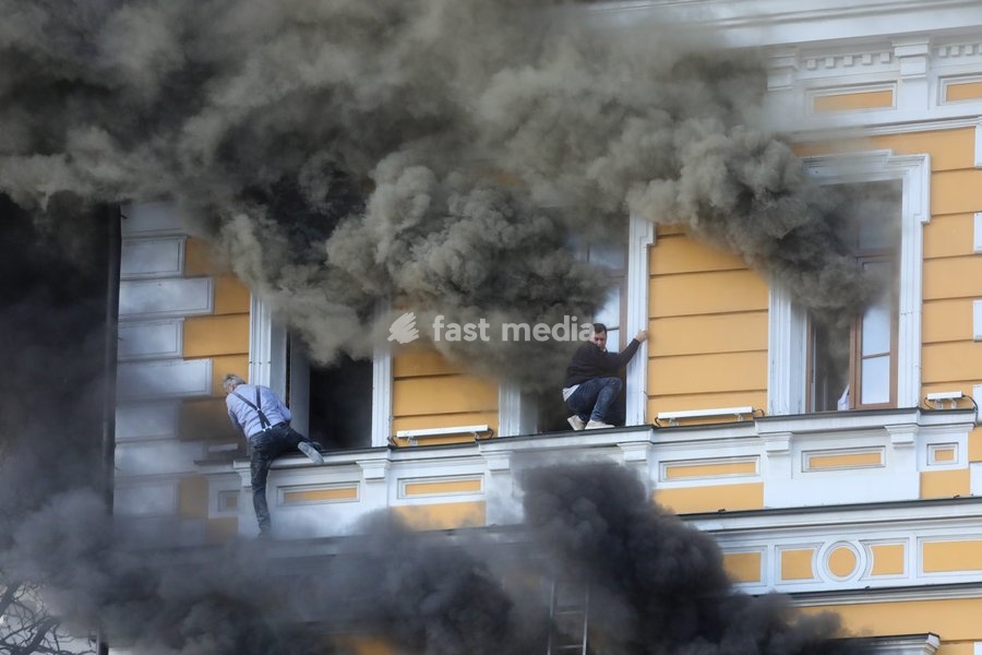 Two men attempt to escape from the National Academy of Sciences building, which is engulfed in flames after being hit by a Russian drone, Kyiv, Ukraine, September 28, 2026. One person was killed, and three others were injured in the attack