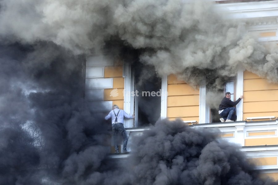 Two men attempt to escape from the National Academy of Sciences building, which is engulfed in flames after being hit by a Russian drone, Kyiv, Ukraine, September 28, 2026. One person was killed, and three others were injured in the attack