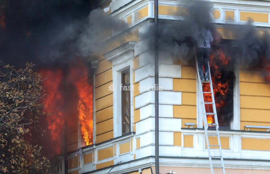 A man goes down a telescopic ladder to escape from the National Academy of Sciences building, which is engulfed in flames after being hit by a Russian drone, Kyiv, Ukraine, September 28, 2026. One person was killed, and three others were injured in the attack