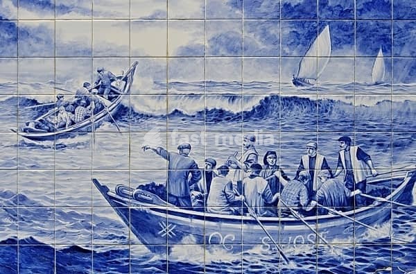 Portuguese azulejo mural showing fishermen in traditional boats navigating a choppy ocean
