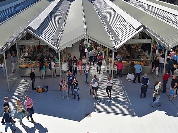 People enjoying the vibrant atmosphere and food offerings at the Time Out Market in Lisbon