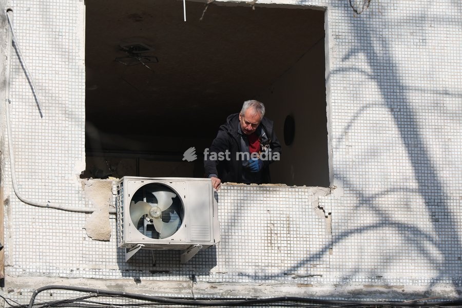 A man inspects an air-conditioning unit from a window of a multi-storey residential building damaged by a Russian glide bomb strike in Kharkiv, Ukraine, on September 28, 2026. Russian forces launched glide bomb strikes on the Kyivskyi and Saltivskyi districts of Kharkiv, with one bomb hitting the…
