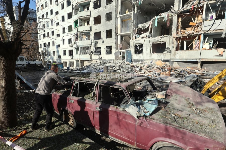 A man stands next to a damaged car near a multi-storey residential building hit by a Russian glide bomb in Kharkiv, Ukraine, on September 28, 2026. Russian forces launched glide bomb strikes on the Kyivskyi and Saltivskyi districts of Kharkiv, with one bomb hitting the apartment building. More than…