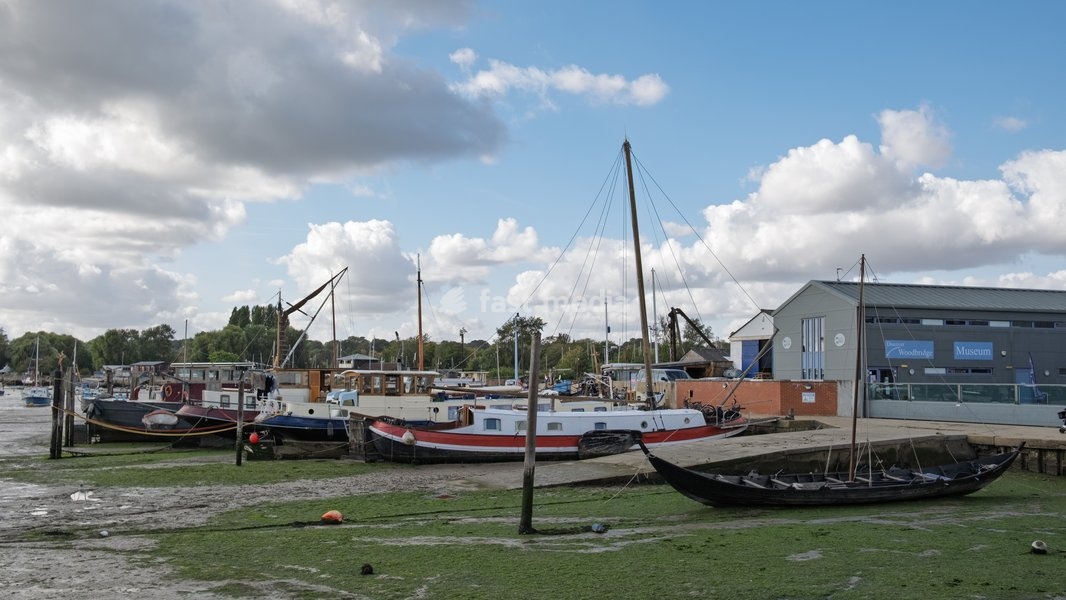 Boats by the quayside including a Viking replica boat. Woodbridge on the River Deben near Ipswich, Suffolk. United Kingdom. 02 October 2026