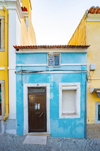 Traditional small house with bright blue facade in Ajuda, Lisbon, a historic district known for its old architecture and charm