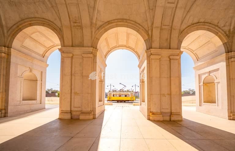 Lisbon, Portugal, Historic tram framed by neoclassical arches of the royal National Palace of Ajuda