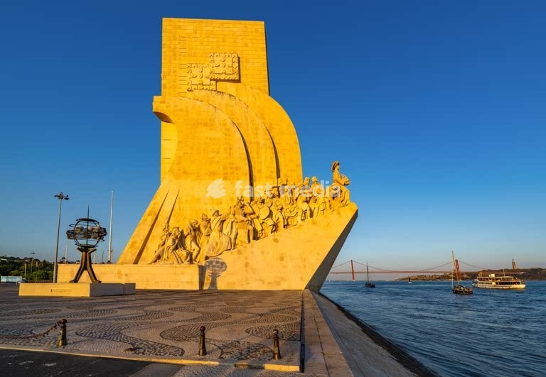 Monument to the Discoveries overlooks Tagus River with 25 de Abril Bridge, Belém, Lisbon, Portugal - iconic limestone memorial to Portuguese explorers
