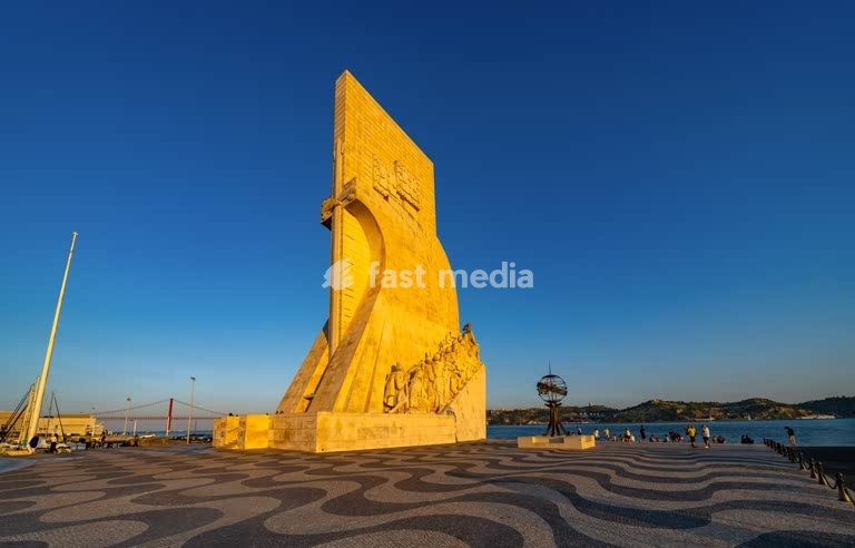 Monument to the Discoveries overlooks Tagus River with 25 de Abril Bridge, Belém, Lisbon, Portugal - iconic limestone memorial to Portuguese explorers