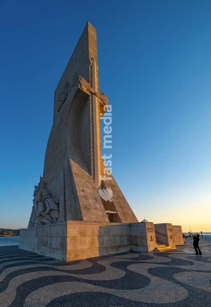 Padrão dos Descobrimentos monument on Tagus riverfront, Belém district, Lisbon, Portugal with iconic red suspension bridge backdrop