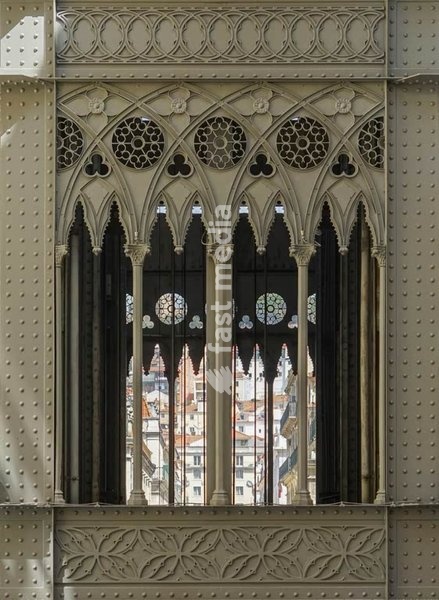 Lisbon, Portugal – neo-Gothic ironwork detail of the Santa Justa Lift with city view through the arches