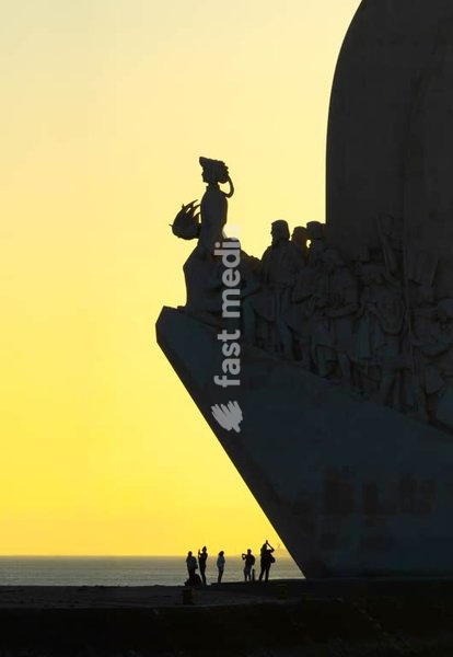 Silhouetted Monument to Discoveries at sunset along Tagus River waterfront in Belém Lisbon