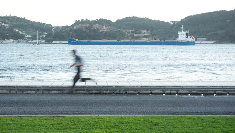 Jogger at Tagus River sunrise – Lisbon Belem Portugal modern minimalist scene
