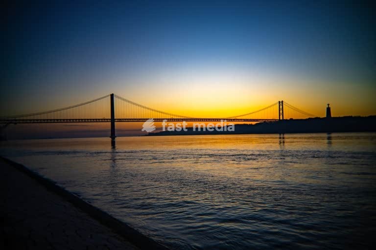 25 de Abril Bridge at sunrise over Tagus River, Lisbon Almada Portugal – skyline with Cristo Rei statue